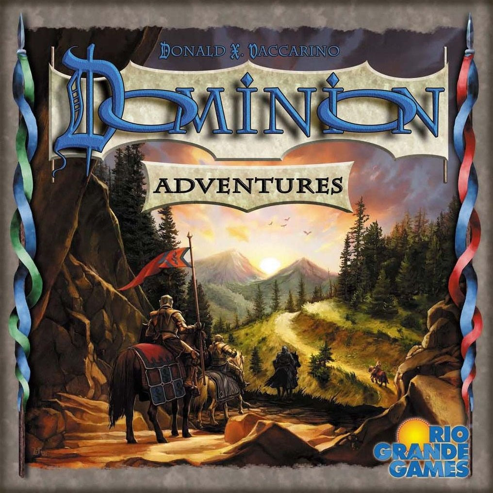 Box cover of Dominion: Adventures Expansion by Rio Grande Games, showing armored riders on horseback traveling a winding path through forested mountains, with the game’s title and publisher logo displayed.
