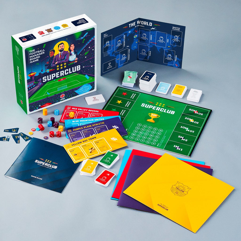 Superclub: The Football Manager Board Game by Superclub is displayed on a table, featuring the box, board, cards, dice, vibrant player folders, tokens, and manuals—everything you need to manage a football club in style.