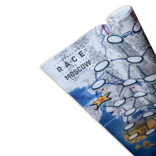 A close-up of a partially rolled 1941: Race to Moscow Giant Playing Mat (126 cm x 84 cm) by Phalanx, showing connected paths and circles over a snowy terrain, with highlighted spots and a visible yellow star.
