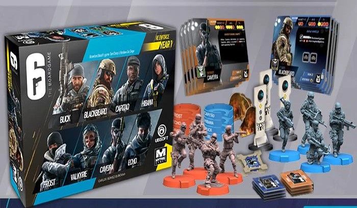 The 6: Siege – The Board Game Bundle by Mythic Games includes a box with character miniatures in blue and orange, game cards, and tokens—all laid out for tactical tabletop play.