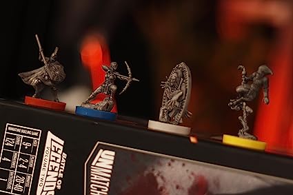 Four detailed fantasy miniatures with colored bases stand on the Unmatched: Battle of Legends, Volume Two (Iello) game box by Iello, capturing the excitement of this asymmetrical board game with unique characters like an archer and a shielded warrior.
