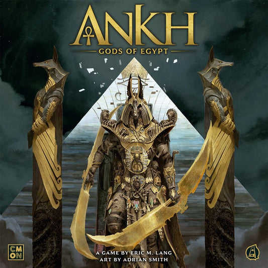 The box art for Ankh: Gods of Egypt by Cool Mini Or Not shows a central pharaoh figure in ornate armor, flanked by two Anubis statues before a pyramid with golden accents and Egyptian motifs.