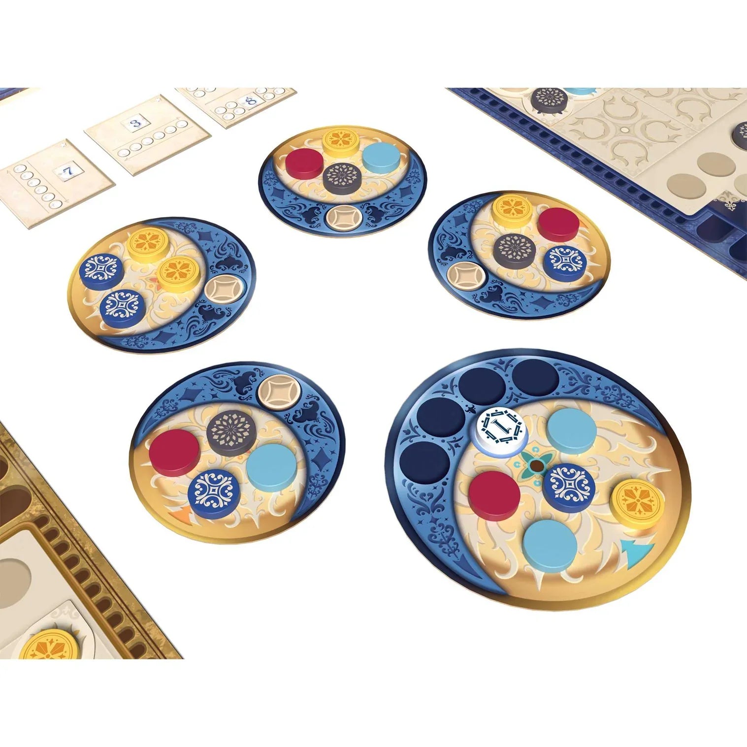 Five ornate round tokens with blue and gold designs, featuring colored disks, are arranged on a tabletop—reflecting the strategic elegance of Azul Duel by Next Move Games, a two-player game that reimagines tile drafting.