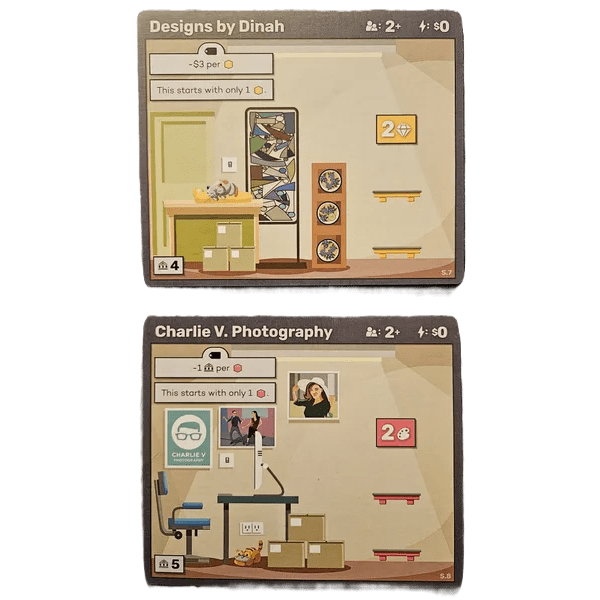 Two illustrated cards from the Brick & Mortar Bundle by Octoraffe Games: Designs by Dinah with shelves, photos, and a cat; Charlie V. Photography with a workspace, camera, and portraits—featuring vibrant art and economic game icons.