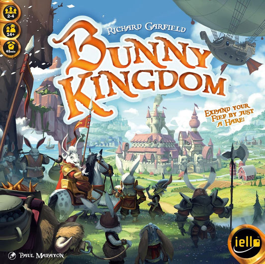 Armored rabbits from a clever clan face a castle in a fantasy land with flying ships above. The strategy board game Bunny Kingdom by Iello is shown, with its title in bold orange letters over the scene.