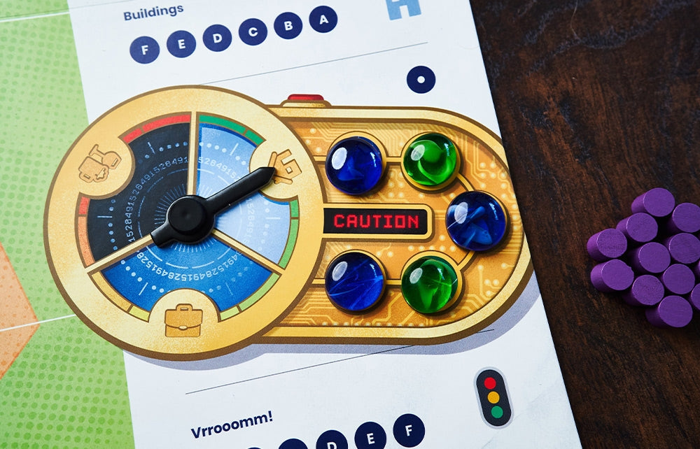 A close-up of a game component from Capstone Games’ Bus: Complete Edition shows a gold circular dial with a black pointer, four glass marbles in various colors, purple tokens, and wooden pieces on the public transport-themed board.