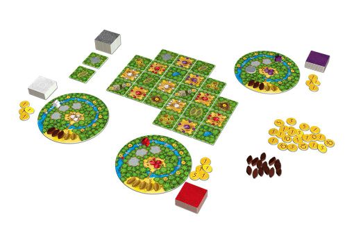 The setup of Cacao NL by White Goblin Games features colorful circular player boards, square tiles in a grid, various tokens, and small brown pieces with red, white, and purple boxes on a white background.