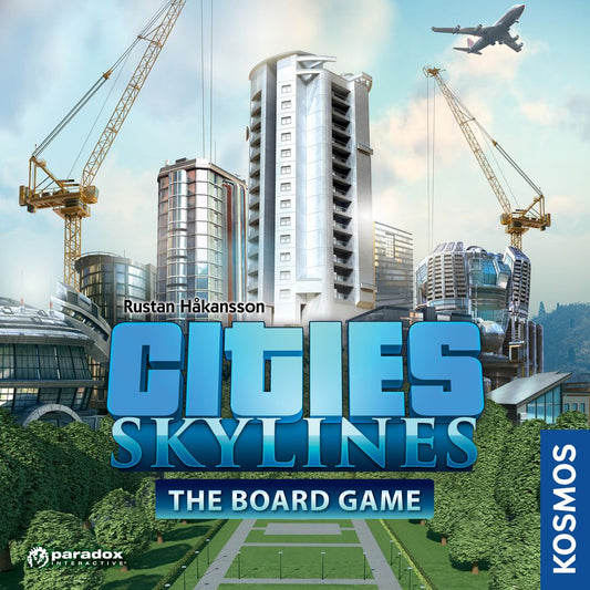 The cover of Cities: Skylines The Board Game by Kosmos features modern skyscrapers, construction cranes, a flying airplane, and green lawns, with the game's bold blue title and the Kosmos logo on the side.