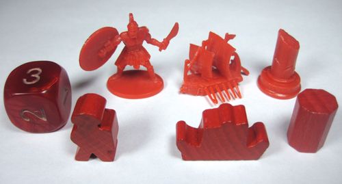 Cyclades by Matagot features red game pieces inspired by Ancient Greek strategy: a 6-sided die, Roman soldier miniature, ship, column, meeple, castle wall, and two cylindrical tokens—all displayed on a white background.