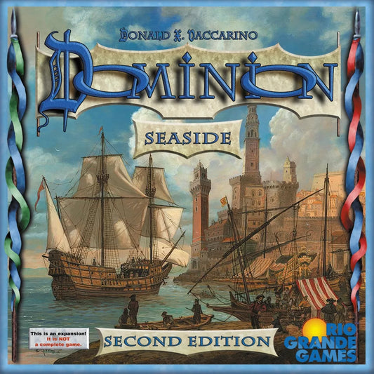 The cover of Dominion: Seaside Expansion (Second Edition) by Rio Grande Games depicts a historic seaside town with ships and towers; the text indicates it's an expansion with new Kingdom cards for Dominion, not a standalone game.