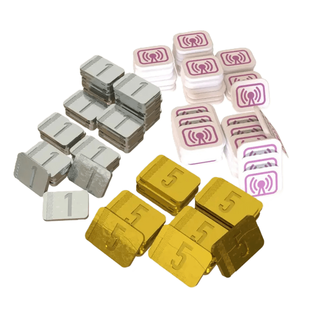 Galactic Cruise: Deluxe Bits by Kinson Key Games features stacks of rectangular tokens—silver (1), gold (5), and white with a purple WiFi-style symbol—perfect as metal money or acrylic ad tokens, shown separately on a white background.