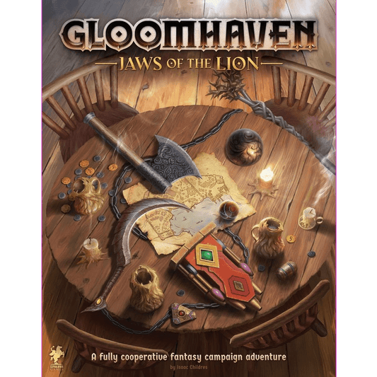 The cover art for Cephalofair Games’ Gloomhaven: Jaws of the Lion shows an ornate wooden table scattered with weapons, maps, coins, mugs, dice, a candle, and the game’s title at the top.