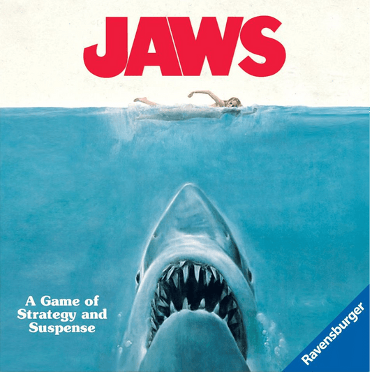 A giant shark swims upward toward a woman on the ocean’s surface, evoking suspense. The bold red “JAWS” title is above, with “A Game of Strategy and Suspense” below—experience the thrill of Ravensburger’s Jaws board game.