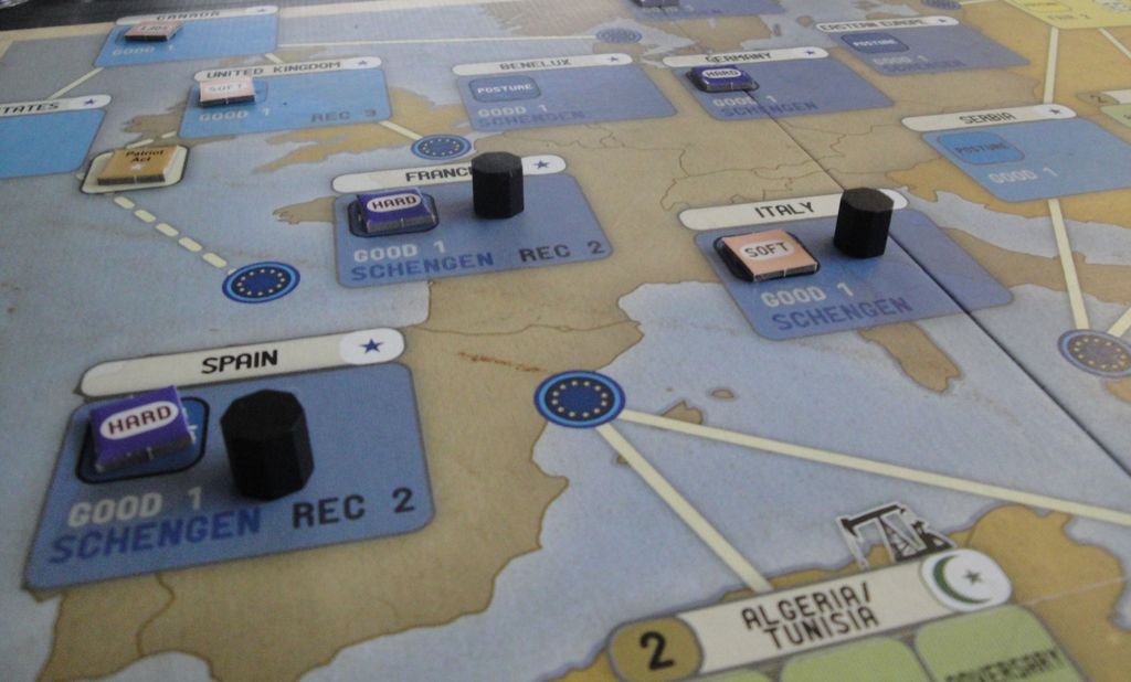 A close-up of Labyrinth: The War on Terror, 2001 – ? by GMT Games shows a map of Europe with labeled areas like Spain and France, plus wooden pieces and tiles marked HARD and SOFT reflecting post-9/11 geopolitical shifts.