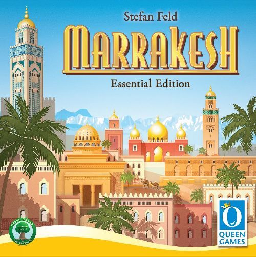 Board game cover for Marrakesh (Essential Edition) by Queen Games, showcasing vibrant Moroccan architecture, palm trees, domes, minarets under a blue sky, and the signature cube tower. Brand and award logos appear in the corners.