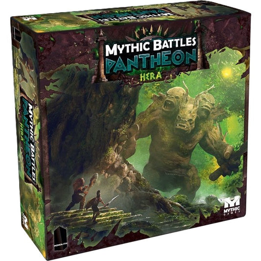The box cover of Monolith's Mythic Battles: Pantheon Hera Expansion shows two warriors facing a three-headed beast in a lush, mystical forest, recalling the epic 12 Labours of Heracles.