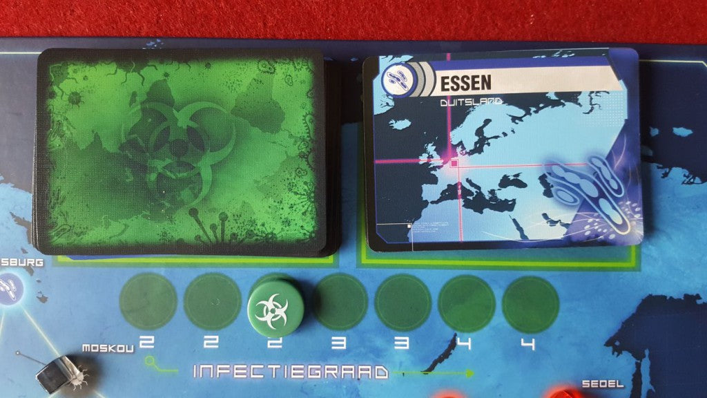 Pandemic NL by Z-Man Games features a cooperative setup with a green biohazard deck and an Essen card, displayed on a blue Europe-Asia map with infection markers.