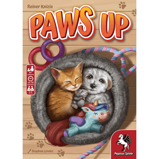 The Paws Up card game by Pegasus Spiele features a cute kitten and puppy cuddling in a fluffy bed with a toy unicorn, surrounded by colorful ropes and rings. Game info icons and the Pegasus Spiele logo also appear on the cover.