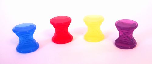 Four small, hourglass-shaped plastic pieces in blue, red, yellow, and purple from Ndemic Creation’s Plague Inc. are lined up on a white surface—ideal as player tokens for the popular board game.