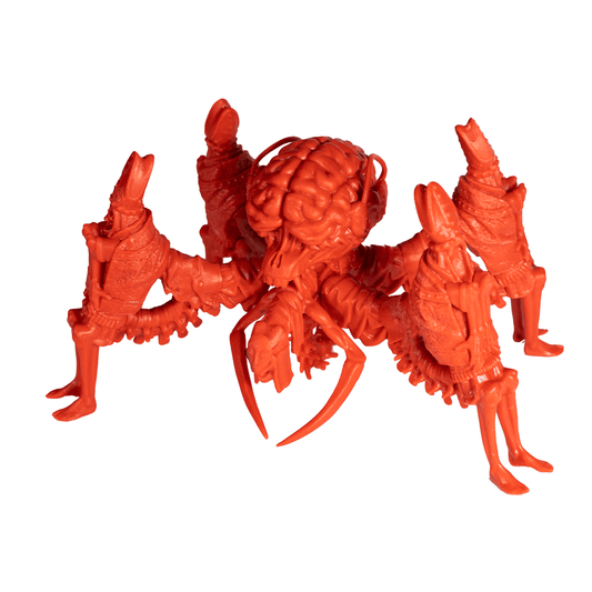 A red plastic toy figure from Petersen Games' Planet Apocalypse: Spider Mastermind Expansion features a brain-like body, crab-like claws, multiple legs, and humanoid traits, displayed against a white background.
