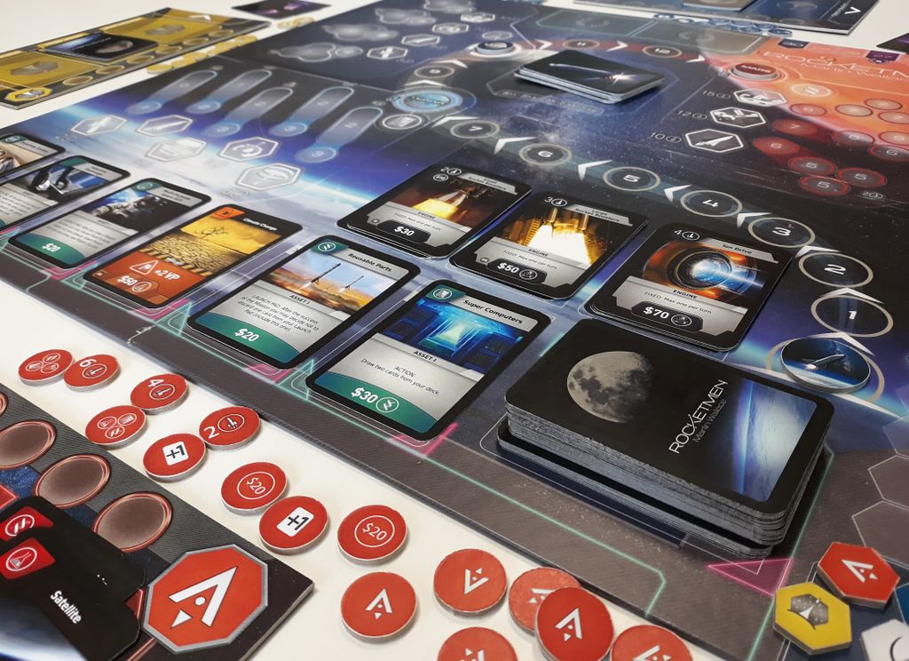 The Rocketmen board game by Phalanx is a sci-fi deck-builder, featuring cards, tokens, and a colorful futuristic board with currency values—all set up for an epic space exploration adventure.