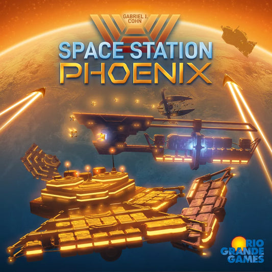 Futuristic space stations orbit a glowing planet lit in orange and blue as beams shoot outward. The text “Space Station Phoenix” spotlights this epic board game by Rio Grande Games, with their logo shown in the corner.
