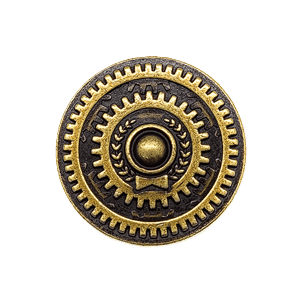 The Eagle-Gryphon Games Weather Machine: Metal Nobel Prize pin features a round gold and black design with gear-like patterns, a central raised circle, laurel leaves on each side, and a small bowtie below, shown on a light gray background.