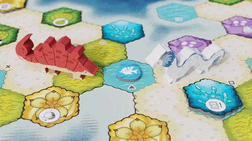 Two wooden game pieces—a red stegosaurus and a white dragon—stand on the vibrant hexagonal board of Wondrous Creatures by Bad Comet, perfect for strategy fans who love colorful icons, flowers, and varied terrain.