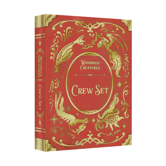 The Wondrous Creatures: Crew Set Expansion by Bad Comet is a red and gold hardcover book with ornate designs and illustrations of fantastical creatures, including a dragon and a bird, on the cover and spine.