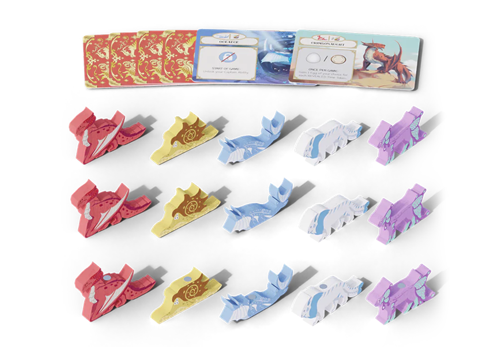 The Wondrous Creatures: Crew Set Expansion by Bad Comet features dragon-shaped pieces in red, yellow, blue, white, and purple, four Crew Cards with red and gold backs, plus two open cards with instructions or objectives.