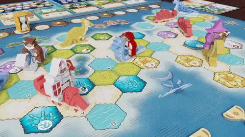 Bad Comet’s Wondrous Creatures: Gargantuan Beasts Expansion showcases animal and dinosaur figures on hexagonal terrain tiles, plus cards and tokens—including expansion pieces—arrayed along the board’s edge.