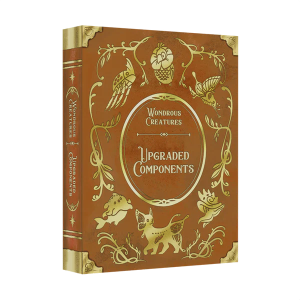 The Wondrous Creatures: Upgraded Components Expansion by Bad Comet is a decorative brown hardcover with gold-embossed whimsical animal illustrations, perfect for fans of unique wooden or metal upgrades.