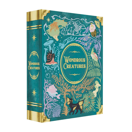 Wondrous Creatures by Bad Comet is a teal hardcover book with gold accents, showcasing whimsical illustrations of mythical animals, plants, fish, and faces for a magical, fantasy-inspired look.