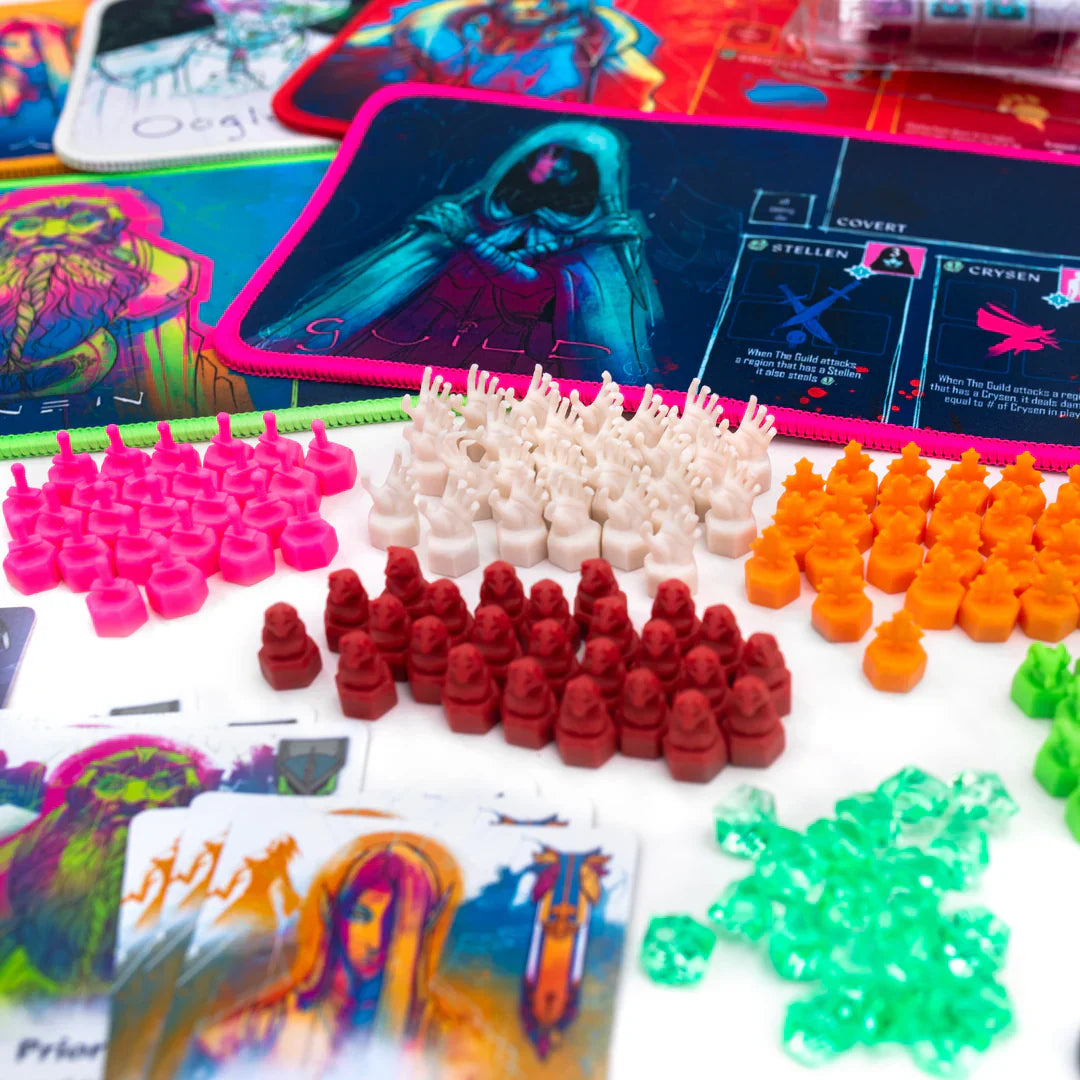 Colorful plastic pieces, fantasy art cards, and vivid player mats from Chip Theory Games’ "Wroth: All Gameplay" are spread out on a tabletop, hinting at an area control board game with asymmetric abilities.
