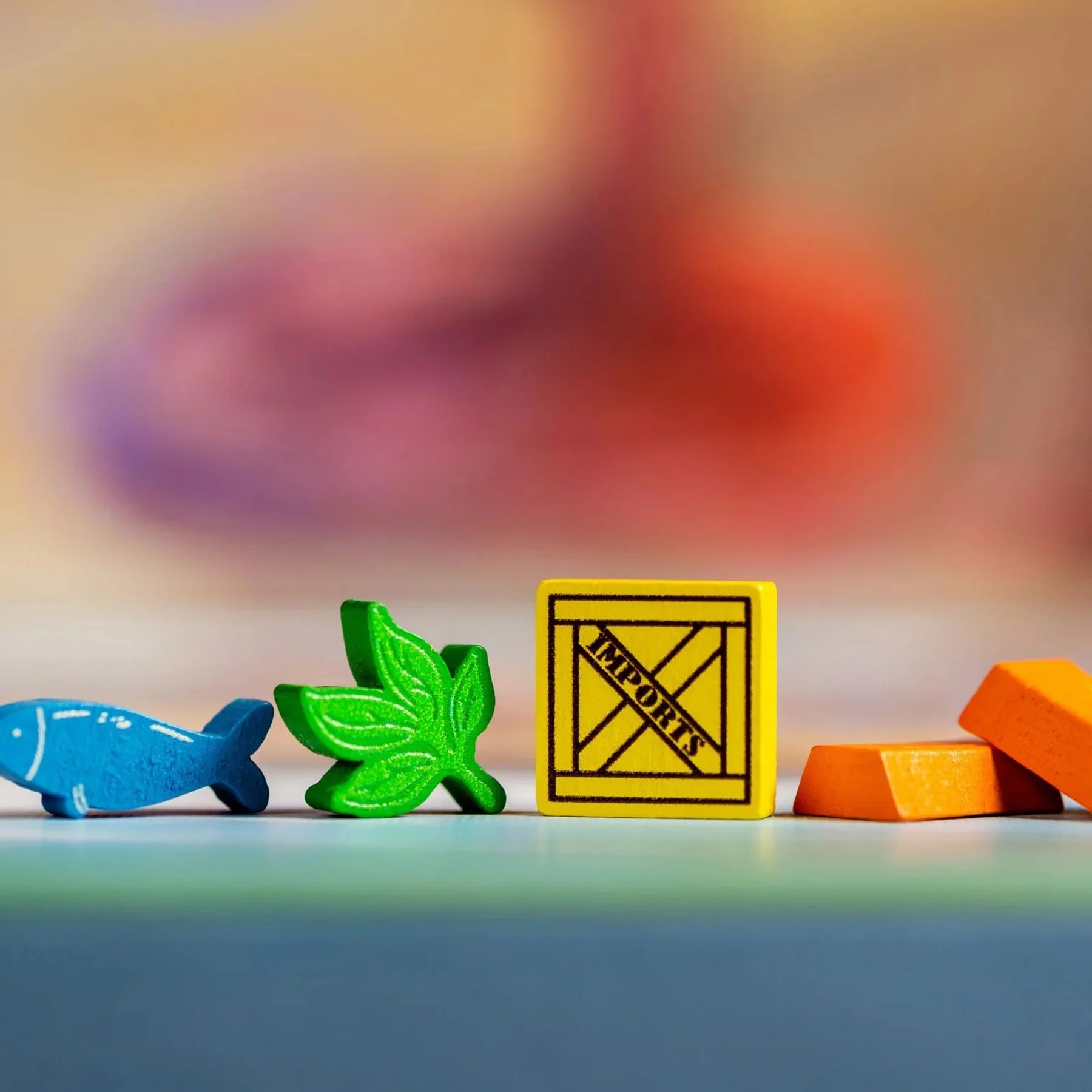 Enhance your Yokohama board game with Synapses Games' Premium Tokens—featuring a blue fish, green leaf, yellow "IMPORTS" square, and orange rectangles—ideal colorful pieces to upgrade your accessories collection.