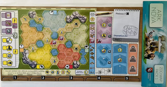 A vibrant Ark Nova: Zoo Map Pack 1 game board displays hexagonal enclosures, player tokens, notepads for notes and scores, and a Zoo Map Pack 1 rulebook with animal images, showcasing the range of zoo maps available.