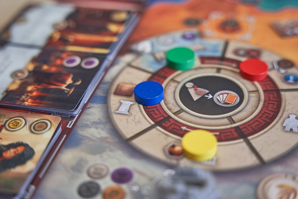 Board game with colorful tokens and cards on a table