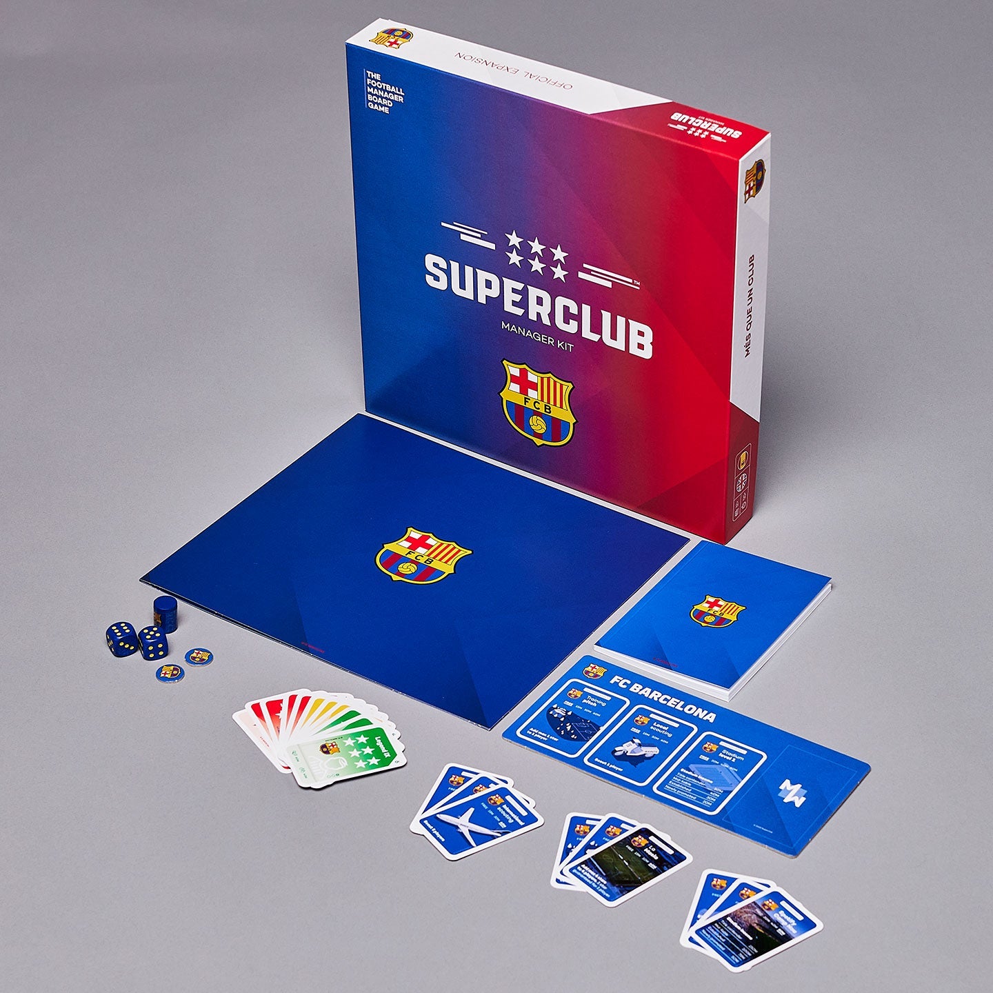 The Superclub: FC Barcelona Manager Kit by Superclub is a tabletop game for football manager fans, featuring a branded game box, cards, board, dice, tokens, and the Superclub trophy—displayed neatly on a gray surface.